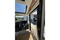 Interior view of 2021 Nimbus C8 boat cockpit with steering wheel and sunroof.