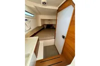 2021 Nimbus C8 cabin interior with bed, wooden accents, and compact design.
