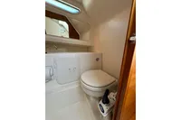 Compact bathroom in 2021 Nimbus C8 boat with toilet and mirror.