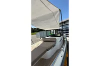 2021 Nimbus C8 boat with canopy, docked outdoors, showcasing sleek design and comfortable seating.