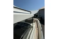 2021 Nimbus C8 boat with sleek design and modern features, docked under clear sky.