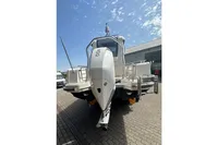 2021 Nimbus C8 boat, rear view, parked outdoors under a clear blue sky.