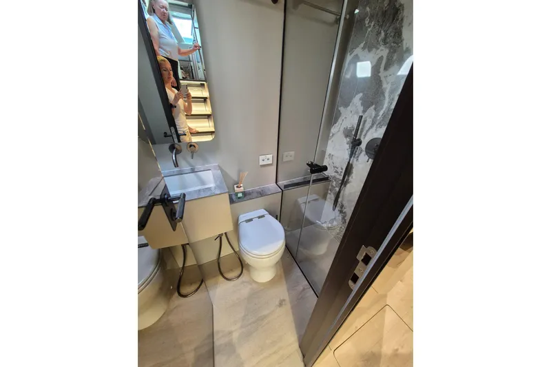 Alemys Yacht Photos Pics Modern bathroom interior on 2023 Sunreef 50 yacht, featuring sleek design and glass shower.