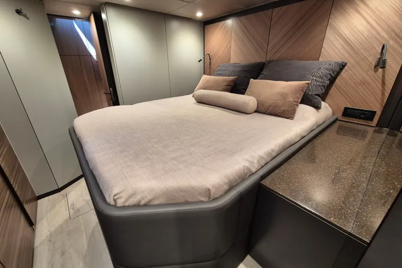 Alemys Yacht Photos Pics Luxurious bedroom interior of 2023 Sunreef 50 yacht with modern design and cozy bedding.