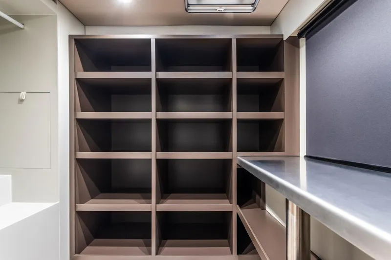 Alemys Yacht Photos Pics Spacious storage shelves in 2023 Sunreef 50 yacht interior.