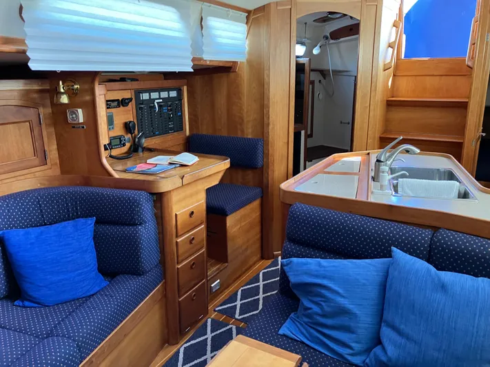 Escapade Yacht Photos Pics Interior of 1997 Sabre 402 yacht with wood finish and blue upholstery.