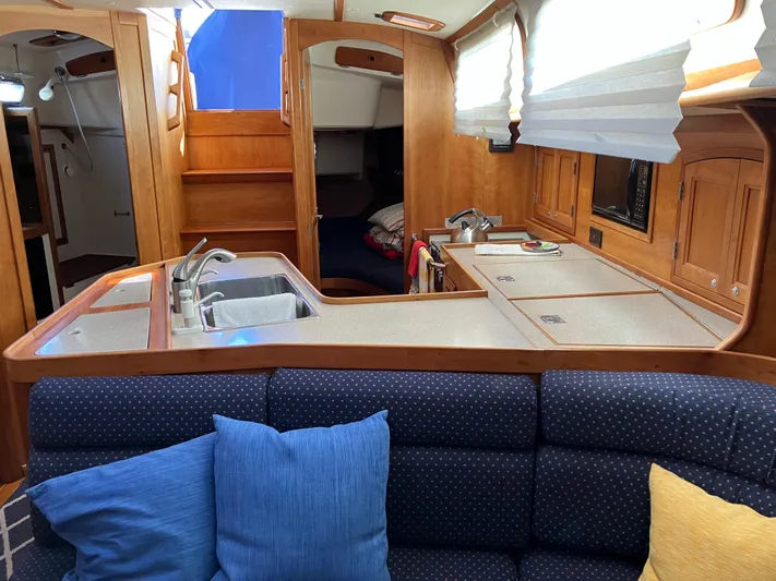 Escapade Yacht Photos Pics Interior of 1997 Sabre 402 yacht with kitchen and seating area.