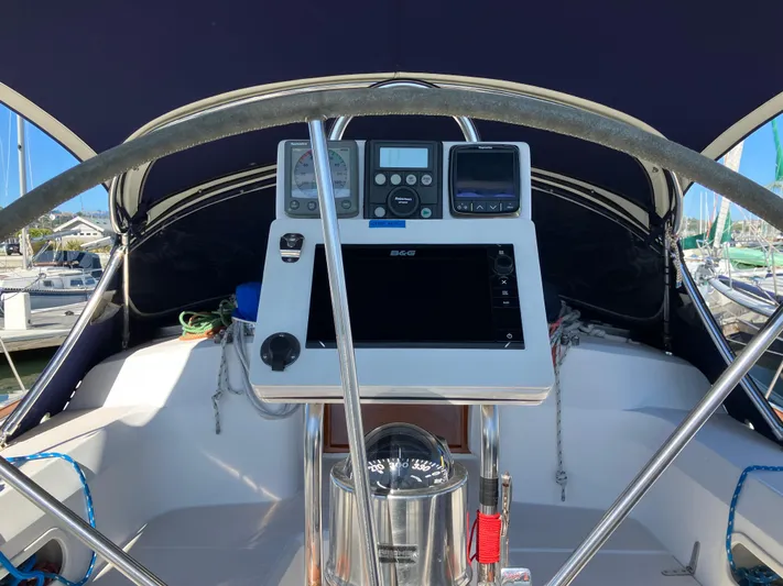 Escapade Yacht Photos Pics Cockpit of 1997 Sabre 402 sailboat with navigation instruments and steering wheel.