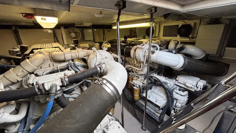  Yacht Photos Pics Engine room of 2003 Sea Ray 680 Sun Sport yacht, showcasing complex machinery and piping.