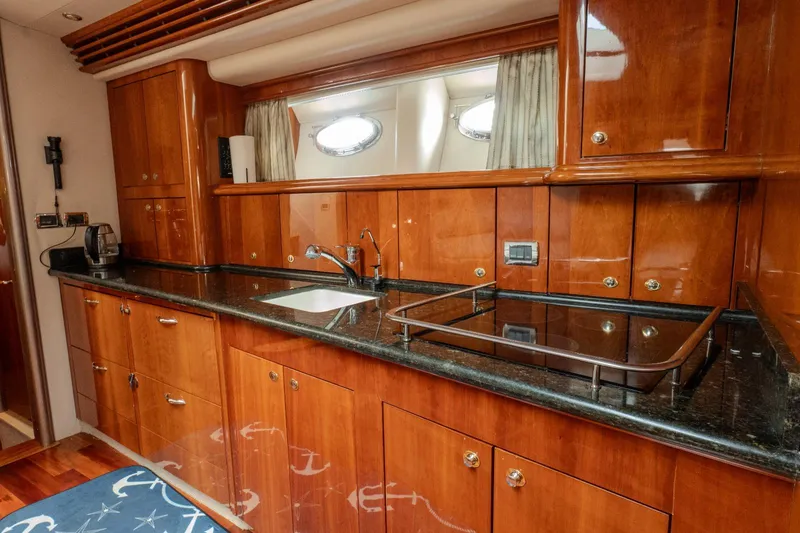  Yacht Photos Pics Luxurious kitchen interior of 2003 Sea Ray 680 Sun Sport yacht with wooden cabinetry.