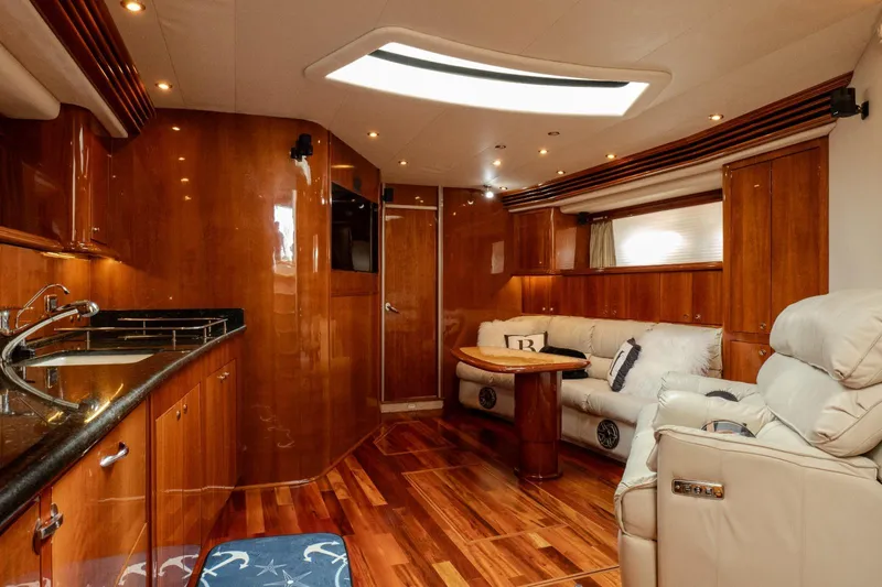  Yacht Photos Pics Luxurious interior of 2003 Sea Ray 680 Sun Sport yacht with wood finishes and plush seating.