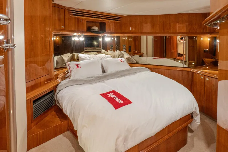  Yacht Photos Pics Luxurious bedroom interior of 2003 Sea Ray 680 Sun Sport yacht with wood paneling.