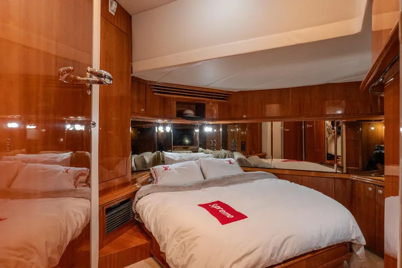  Yacht Photos Pics Luxurious cabin interior of 2003 Sea Ray 680 Sun Sport yacht with cozy bed and wooden finish.