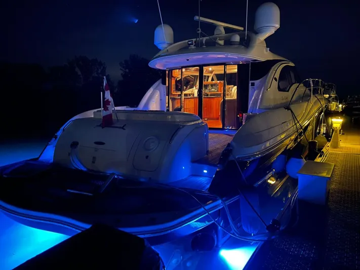  Yacht Photos Pics 2003 Sea Ray 680 Sun Sport yacht illuminated at night with blue underwater lights.