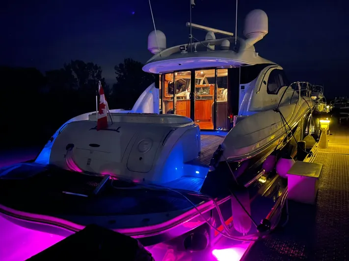  Yacht Photos Pics 2003 Sea Ray 680 Sun Sport yacht illuminated at night with vibrant underwater lights.