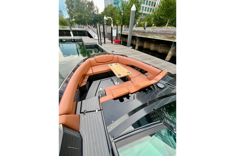  Yacht Photos Pics 2022 Cruisers Yachts 338 South Beach Edition Bow Rider docked, featuring luxurious seating and table.