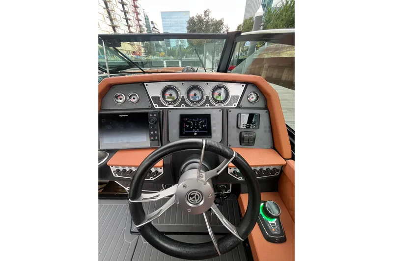  Yacht Photos Pics 2022 Cruisers Yachts 338 South Beach Edition Bow Rider dashboard with modern controls and steering wheel.