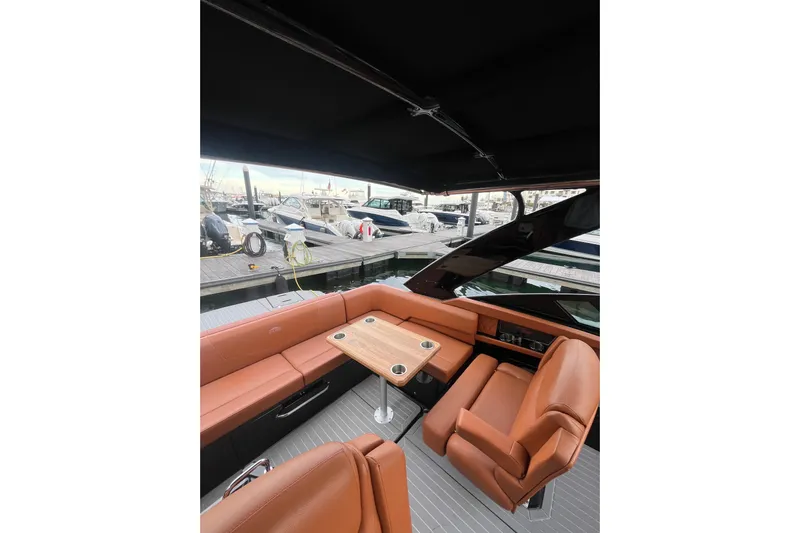  Yacht Photos Pics 2022 Cruisers Yachts 338 South Beach Edition Bow Rider interior with luxurious seating and table.