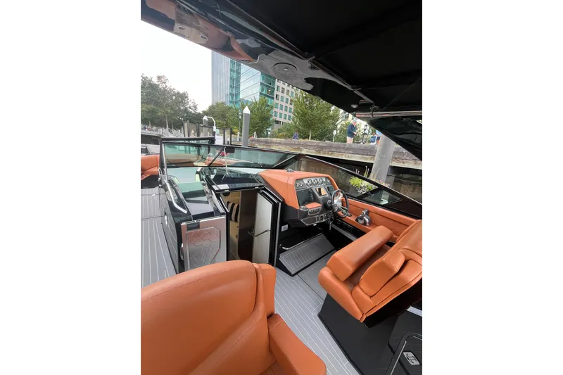  Yacht Photos Pics 2022 Cruisers Yachts 338 South Beach Edition Bow Rider interior with orange seating and modern dashboard.