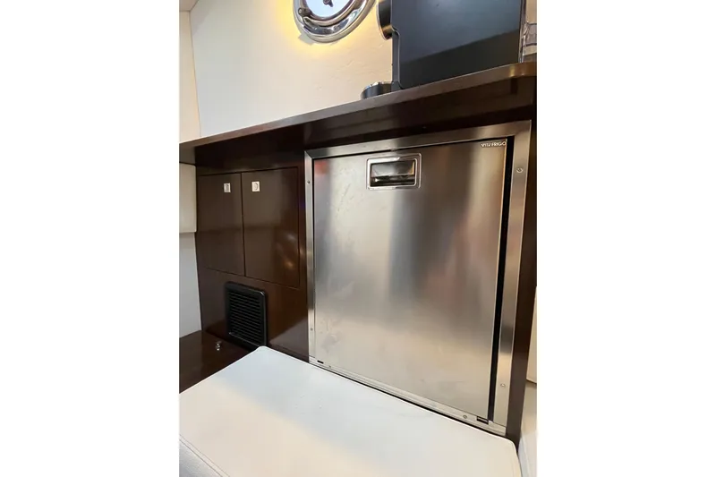  Yacht Photos Pics 2022 Cruisers Yachts 338 South Beach Edition interior with stainless steel fridge.