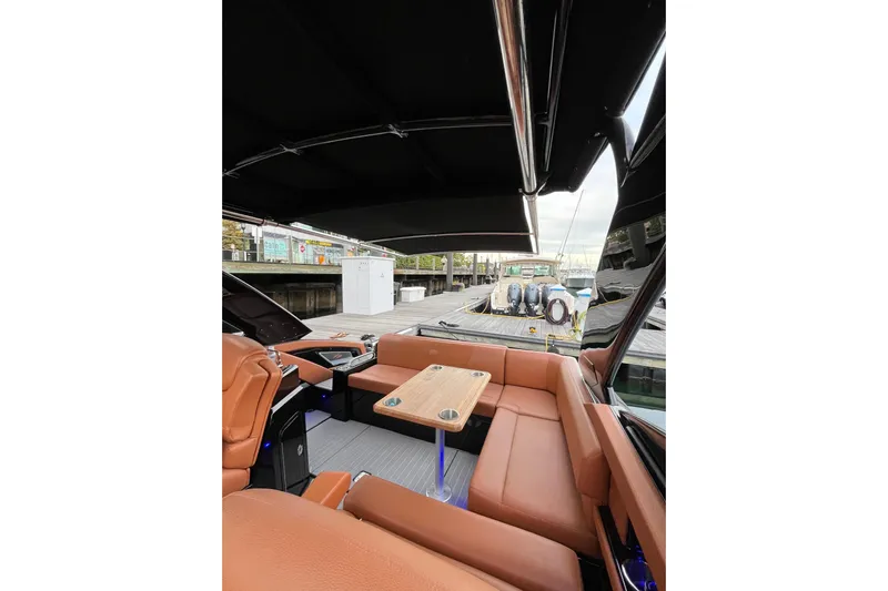  Yacht Photos Pics 2022 Cruisers Yachts 338 South Beach Edition Bow Rider interior with tan seating and wooden table.