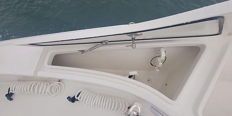 Yacht Photos Pics 2017 SeaVee 270Z boat storage compartment with coiled ropes, open hatch, and ocean background.
