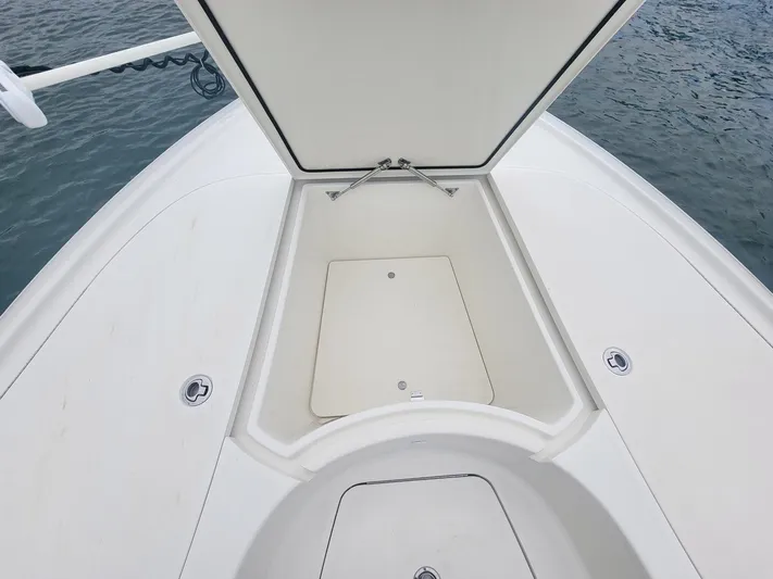  Yacht Photos Pics 2017 SeaVee 270Z boat with open storage compartment on deck, near water.