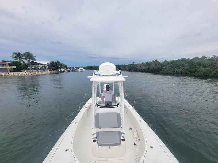  Yacht Photos Pics 2017 SeaVee 270Z boat navigating a calm waterway with lush greenery.