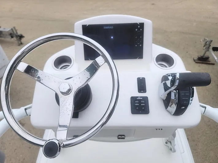  Yacht Photos Pics Steering console of a 2017 SeaVee 270Z boat with controls and display.