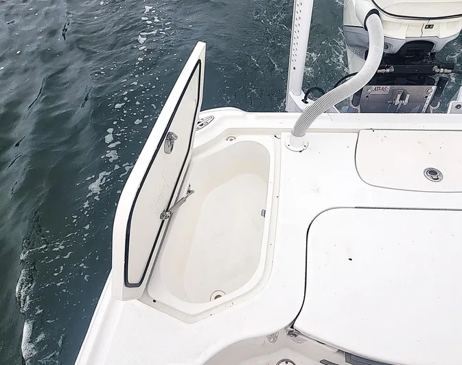  Yacht Photos Pics 2017 SeaVee 270Z boat with open storage compartment on deck, near water.