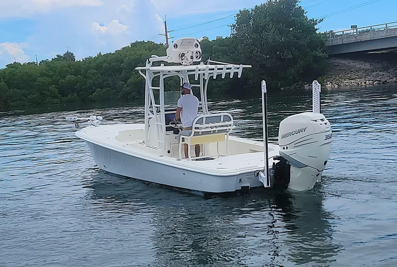  Yacht Photos Pics 2017 SeaVee 270Z boat on water, featuring Mercury engine, near bridge and trees.
