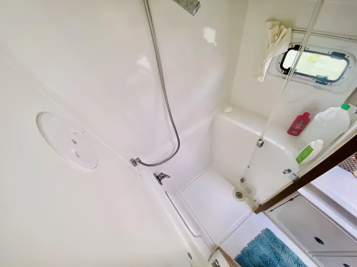 No Schedule Yacht Photos Pics Bathroom interior of 2019 Lagoon 42 Owners Version yacht, featuring shower and window.