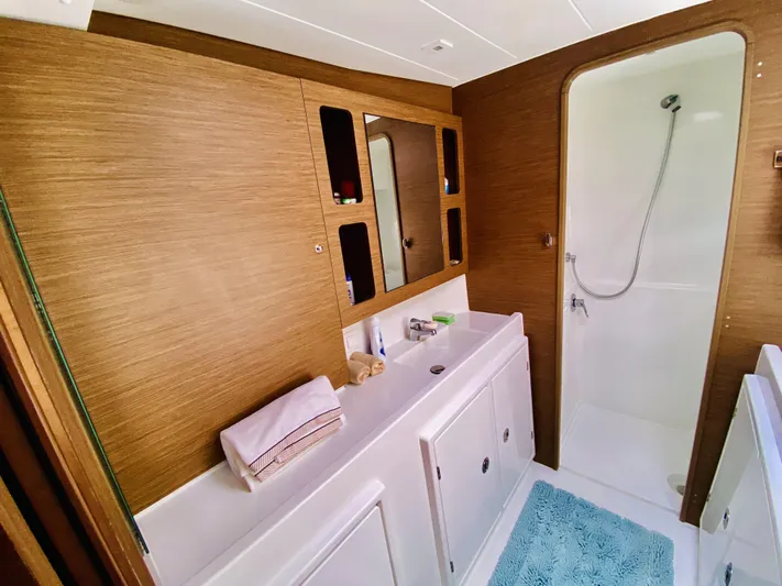 No Schedule Yacht Photos Pics Luxurious bathroom in 2019 Lagoon 42 Owners Version yacht with modern fixtures and wooden accents.