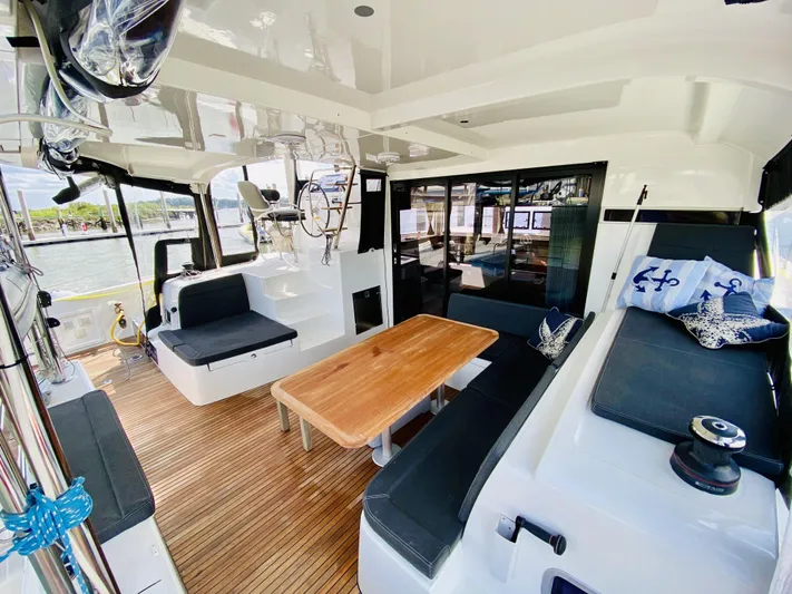 No Schedule Yacht Photos Pics 2019 Lagoon 42 Owners Version yacht interior with seating, wooden table, and nautical decor.