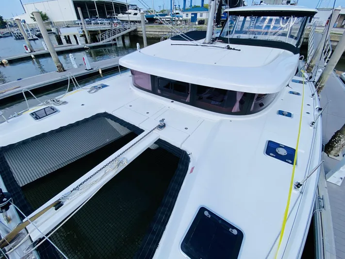 No Schedule Yacht Photos Pics 2019 Lagoon 42 Owners Version catamaran docked at a marina.
