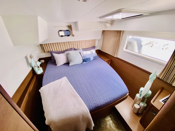 No Schedule Yacht Photos Pics Luxurious bedroom in 2019 Lagoon 42 Owners Version catamaran, featuring cozy bedding and modern decor.