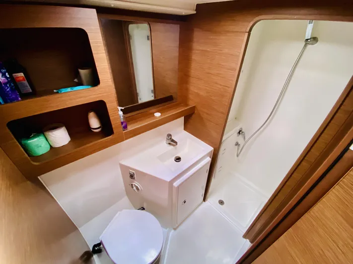 No Schedule Yacht Photos Pics 2019 Lagoon 42 Owners Version bathroom with shower, sink, and storage shelves.