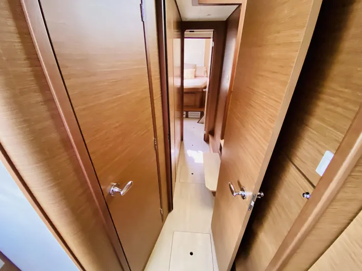 No Schedule Yacht Photos Pics Interior hallway of 2019 Lagoon 42 Owners Version yacht, featuring wooden doors and modern design.