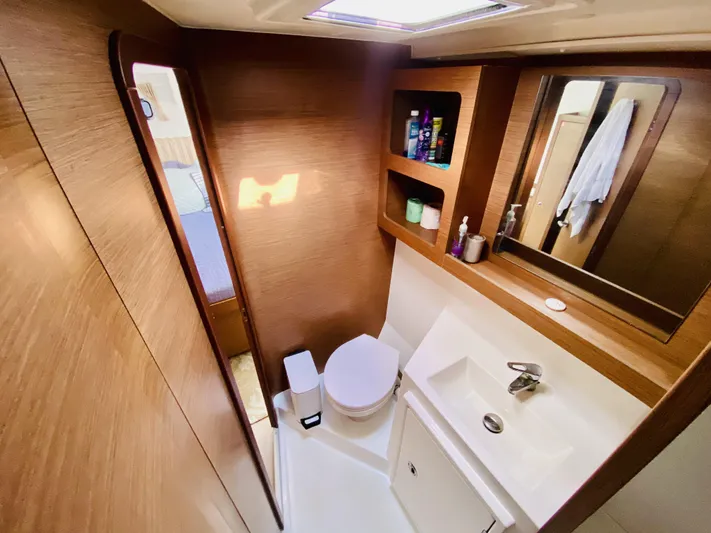 No Schedule Yacht Photos Pics Luxurious bathroom in 2019 Lagoon 42 Owners Version yacht, featuring modern fixtures and wood accents.