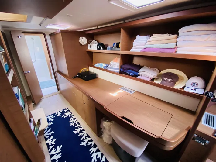 No Schedule Yacht Photos Pics 2019 Lagoon 42 Owners Version interior with wooden shelves, desk, and neatly arranged towels.