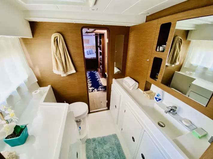 No Schedule Yacht Photos Pics Luxurious bathroom in 2019 Lagoon 42 Owners Version catamaran, featuring modern fixtures and ample storage.