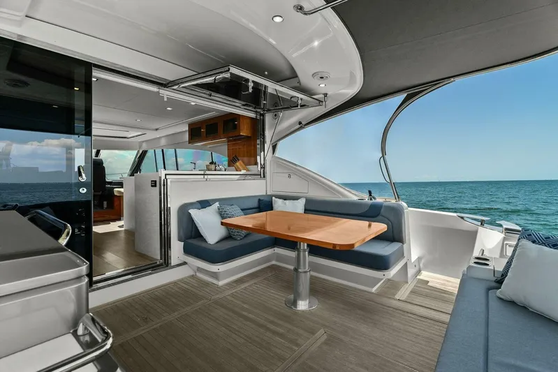 Gia Yacht Photos Pics 2021 Riviera 5400 Sport Yacht with elegant outdoor seating and ocean view.