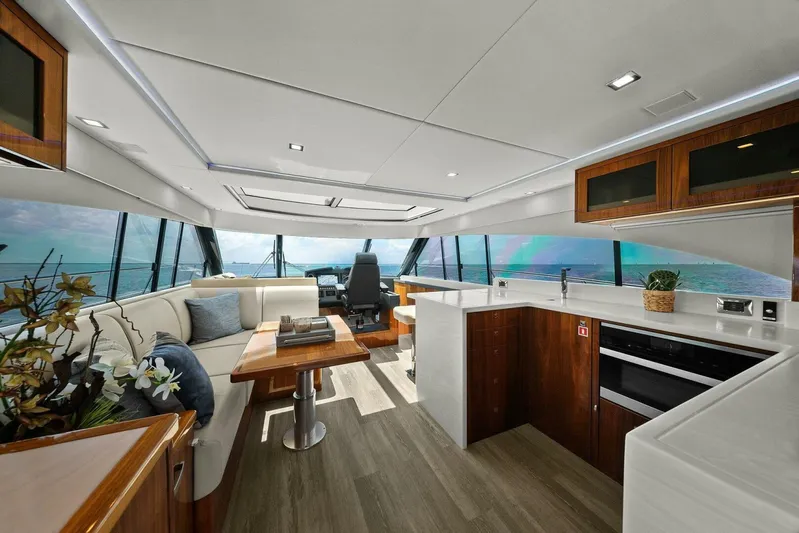 Gia Yacht Photos Pics Luxurious interior of 2021 Riviera 5400 Sport Yacht with modern furnishings and ocean view.