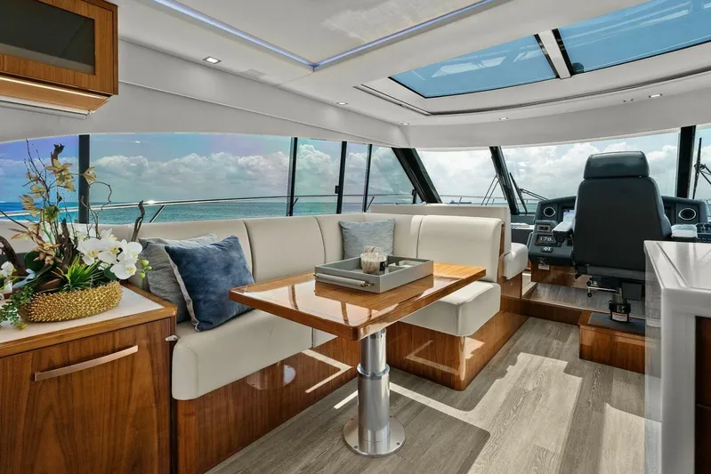 Gia Yacht Photos Pics Luxurious interior of 2021 Riviera 5400 Sport Yacht with elegant seating and panoramic windows.
