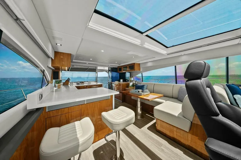 Gia Yacht Photos Pics Luxurious interior of 2021 Riviera 5400 Sport Yacht with modern seating and panoramic windows.