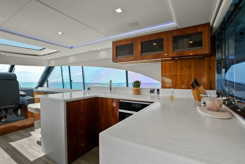 Gia Yacht Photos Pics Luxurious interior of 2021 Riviera 5400 Sport Yacht with modern kitchen and ocean view.