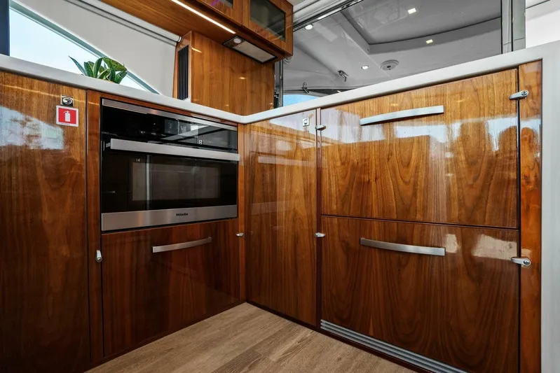 Gia Yacht Photos Pics Luxurious wooden kitchen interior of 2021 Riviera 5400 Sport Yacht.