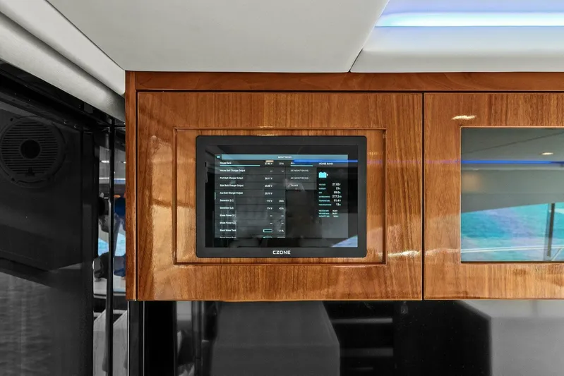 Gia Yacht Photos Pics Control panel on 2021 Riviera 5400 Sport Yacht, featuring sleek wood finish.