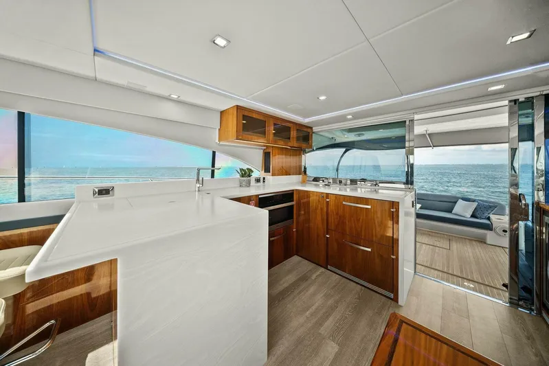 Gia Yacht Photos Pics Luxurious 2021 Riviera 5400 Sport Yacht interior with modern kitchen and ocean view.