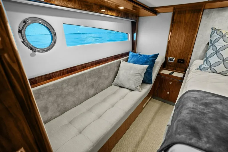 Gia Yacht Photos Pics Luxurious interior of 2021 Riviera 5400 Sport Yacht with plush seating and ocean view.